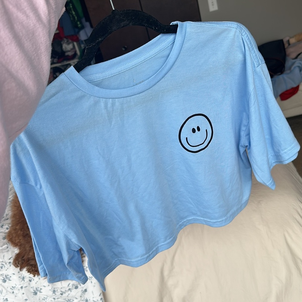 Light blue smiley faced short sleeve cropped tshirt